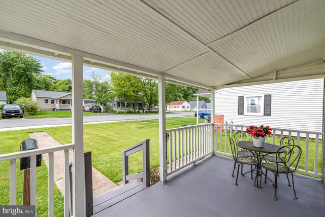 a view of a porch with furniture and garden