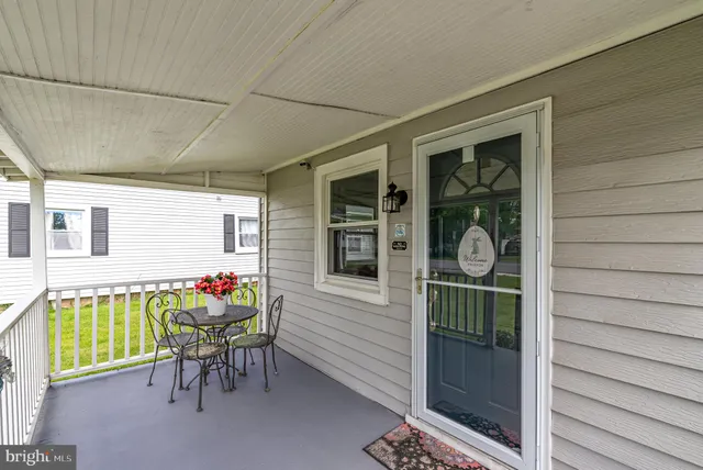 a view of a porch with a table and chairs