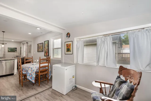 a living room with furniture and large windows