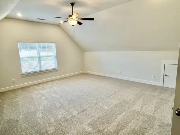 a living room with a large window and a chandelier
