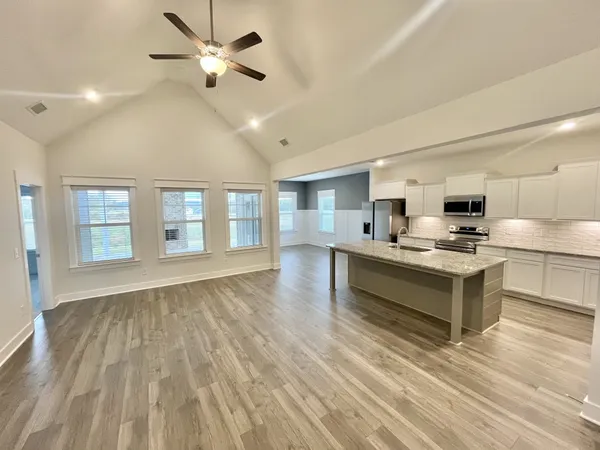 a kitchen with a stove a refrigerator and a sink