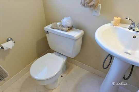 214 South Fire Opal Street Ridgecrest, CA 93555 - Photo 17 of 29 a bathroom with a toilet and sink