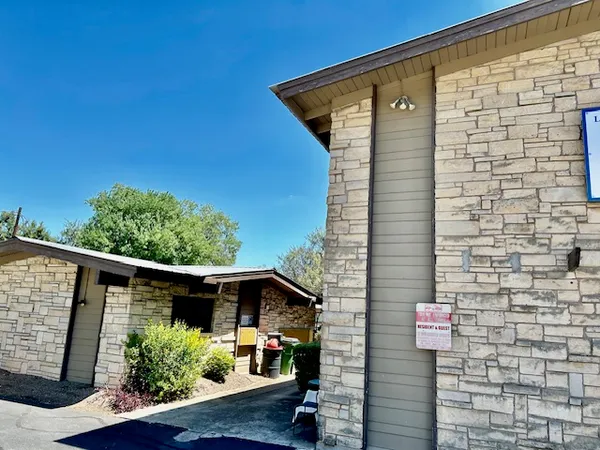 a front view of a house with plants