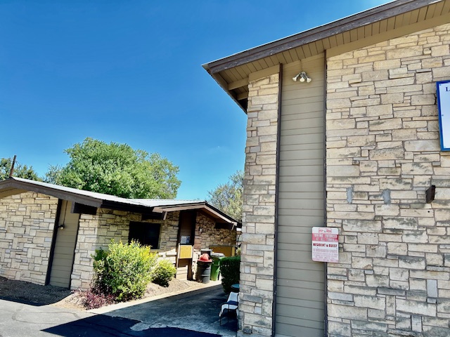 a front view of a house with plants
