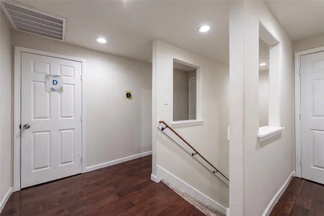 a view of a hallway with the wooden floor
