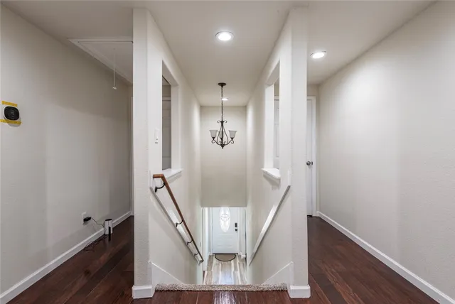 a view of entryway and hall with wooden floor