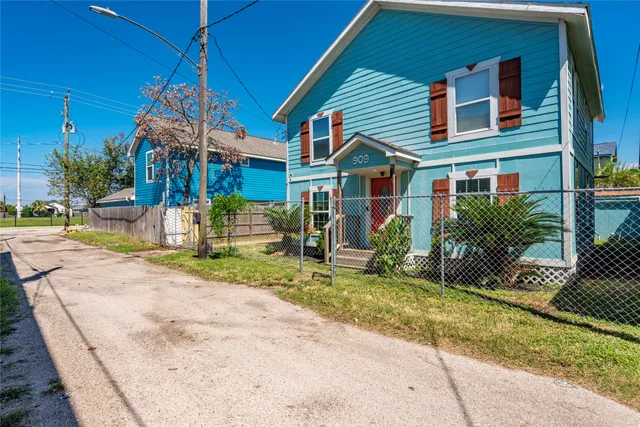 a view of street along with house and trees