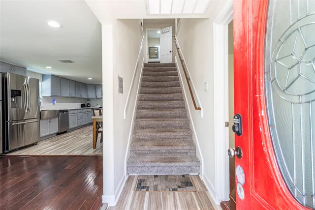 a view of entryway and hall with wooden floor