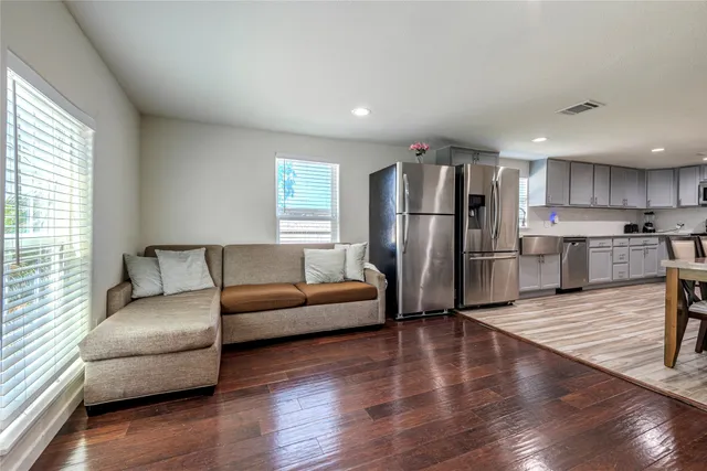 a living room with a couch and a wooden floor