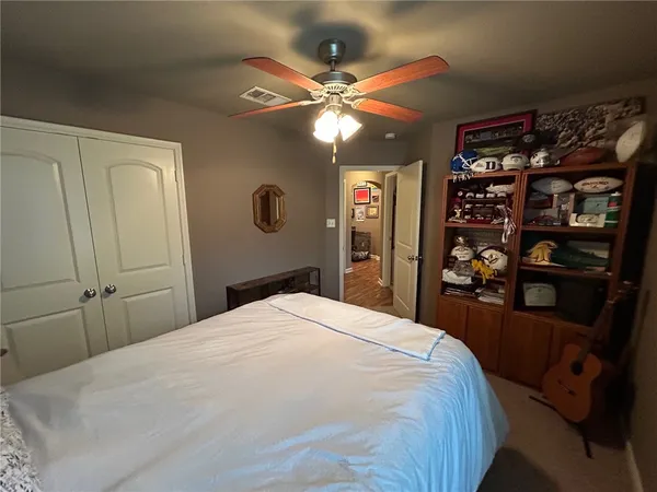 a bedroom with a bed and a chandelier