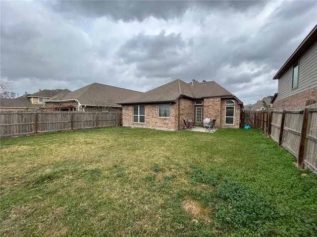 a front view of a house with a garden and yard