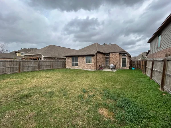 a front view of a house with a garden and yard