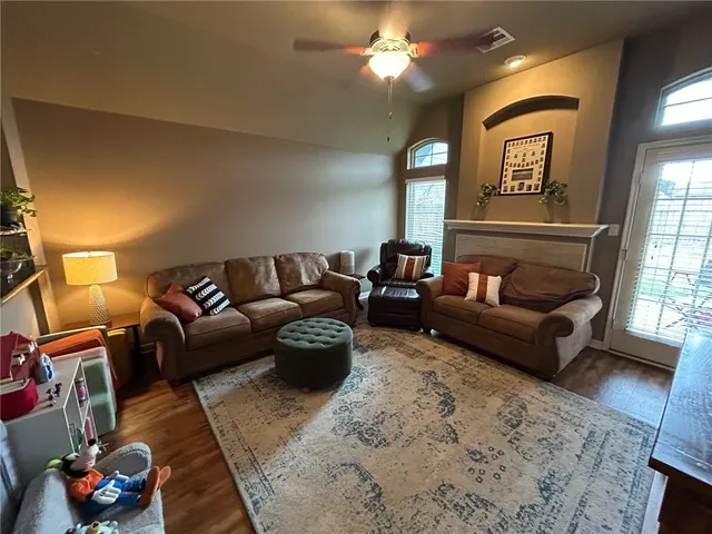 a living room with furniture and a lamp
