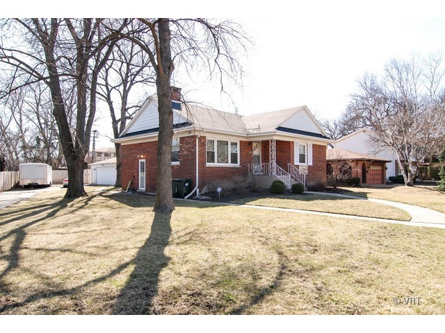 575 Byrd Road Riverside, IL 60546 - Photo 8 of 9 a front view of a house with a yard covered in snow