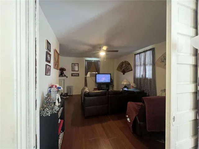 a living room with furniture and a mirror