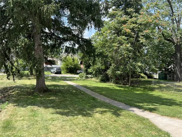 a big yard with lots of green space and trees