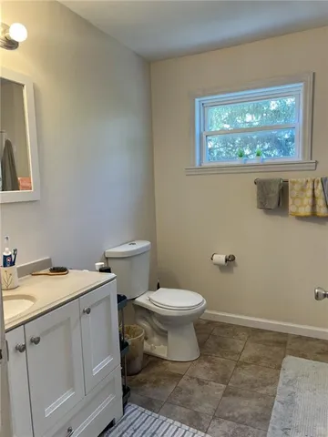 a bathroom with a toilet sink and window