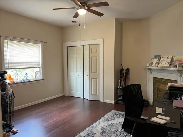 a view of a workspace with furniture and a window