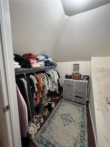 a bedroom with bed and a couch