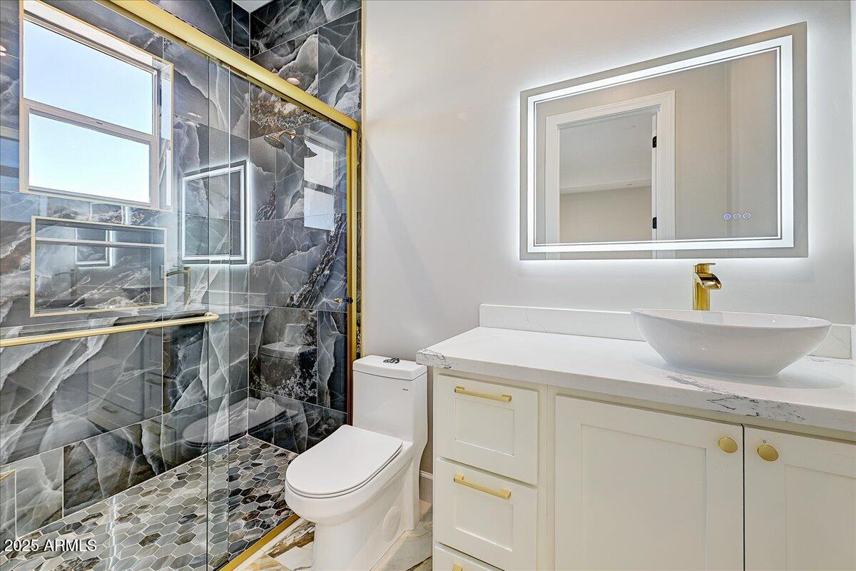 27730 North 35th Avenue Phoenix, AZ 85083 - Photo 18 of 37 a bathroom with a sink toilet and mirror