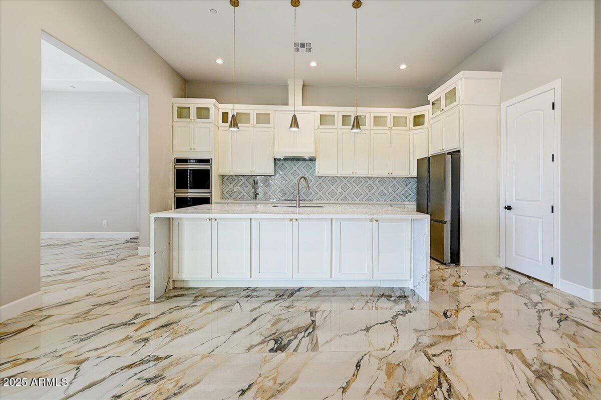 27730 North 35th Avenue Phoenix, AZ 85083 - Photo 20 of 37 a large kitchen with stainless steel appliances kitchen island granite countertop a sink and cabinets
