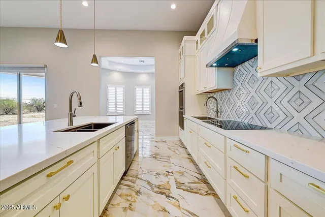 a large kitchen with a sink and cabinets