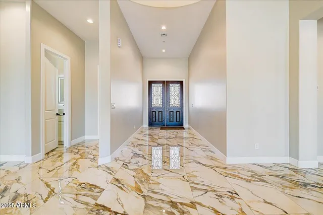 a view of a hallway to bedroom with wooden floor