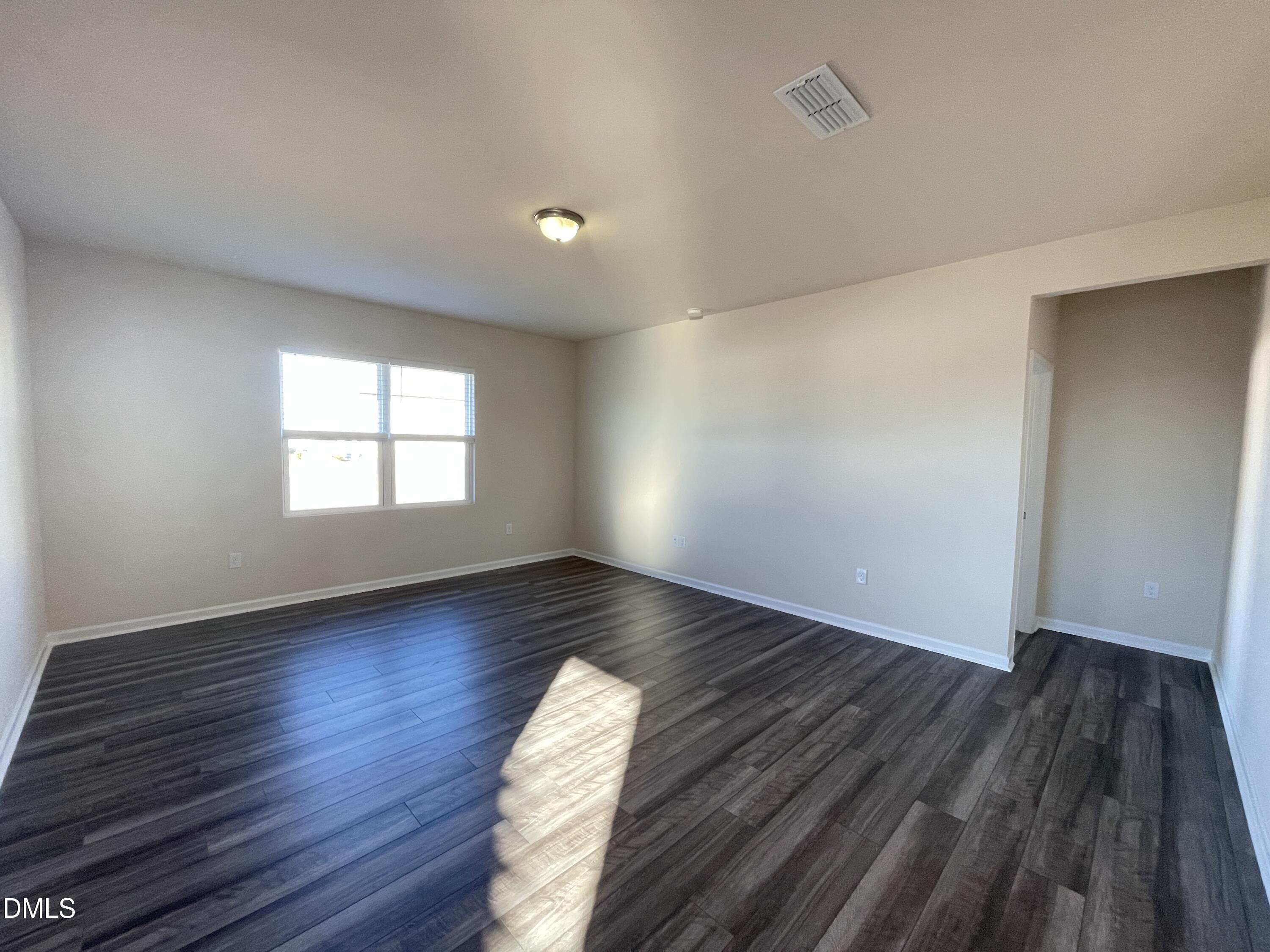 3521 New Town Road Raleigh, NC 27604 - Photo 16 of 24 an empty room with wooden floor and windows