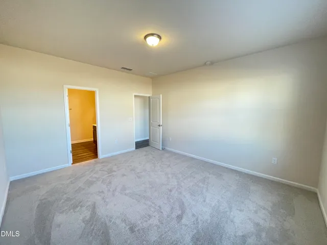 a en suite bathroom with a granite countertop sink and a mirror