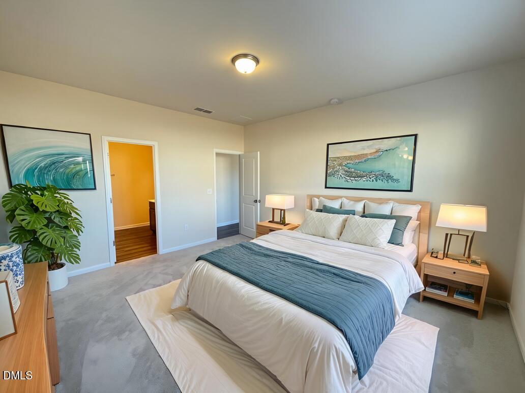 3521 New Town Road Raleigh, NC 27604 - Photo 2 of 29 a spacious bedroom with a large bed and a potted plant