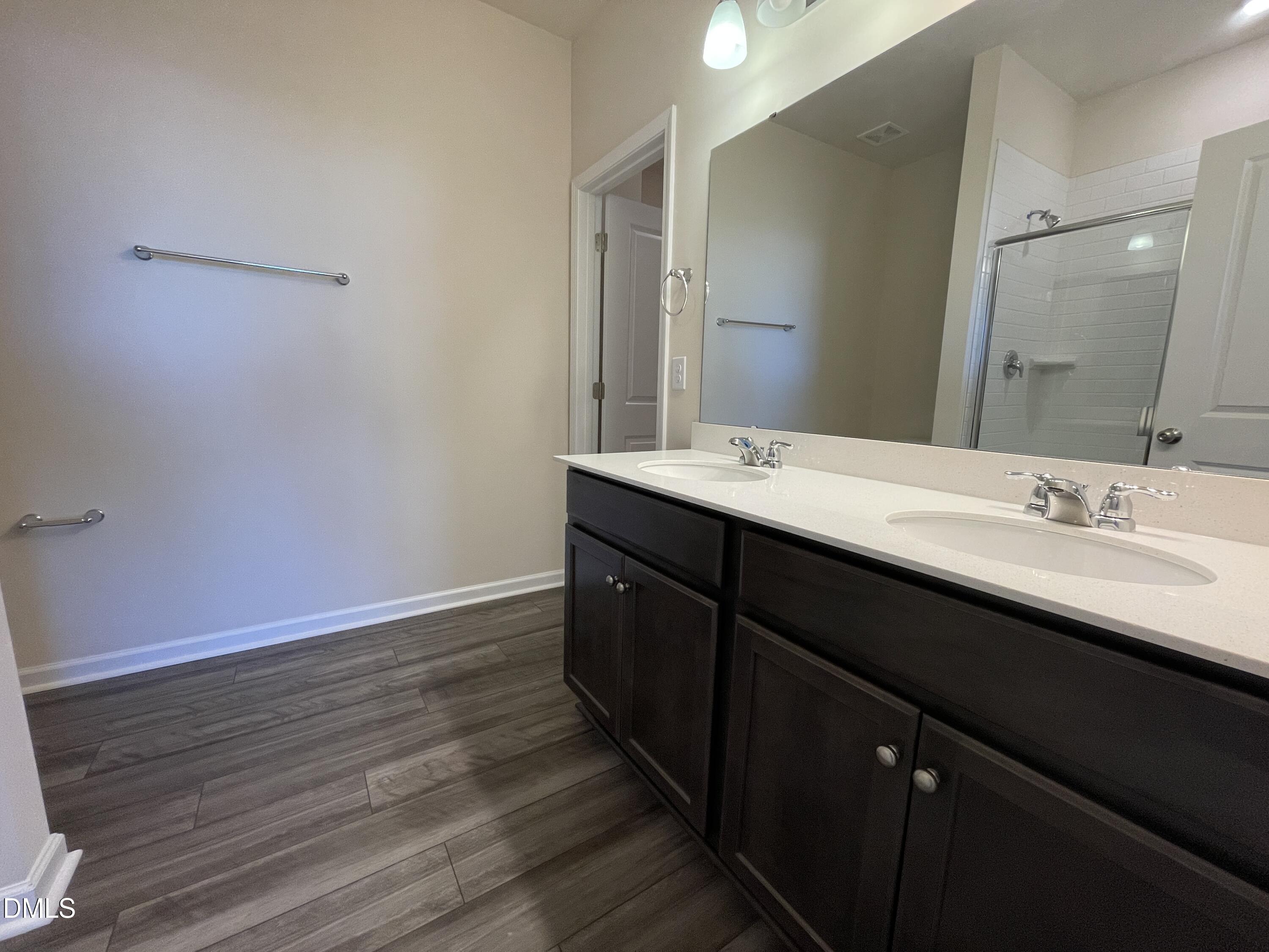 3521 New Town Road Raleigh, NC 27604 - Photo 23 of 29 a en suite bathroom with a granite countertop sink and a mirror
