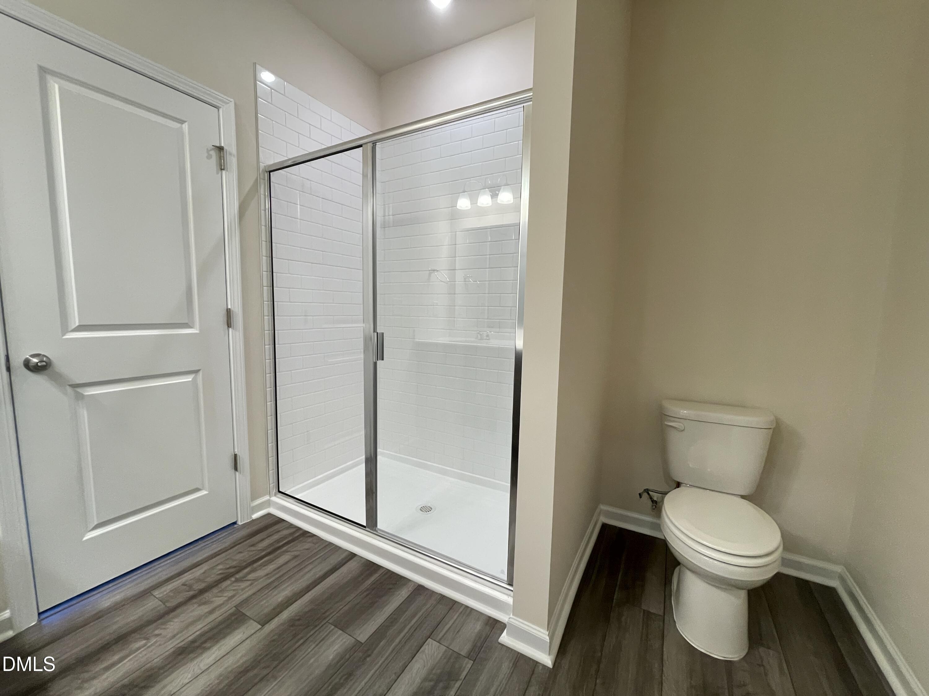 3521 New Town Road Raleigh, NC 27604 - Photo 24 of 29 a bathroom with a toilet and a shower