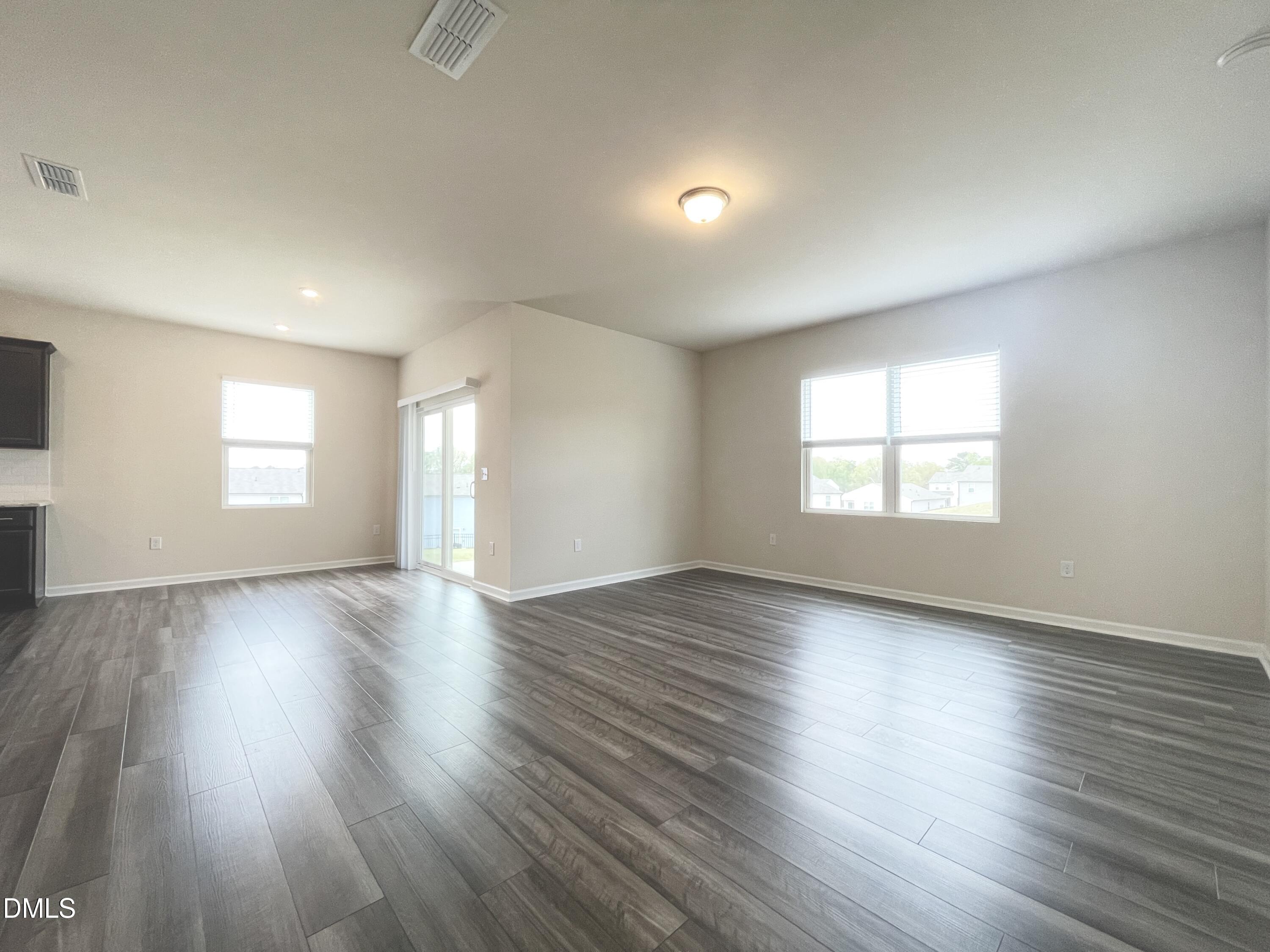 3521 New Town Road Raleigh, NC 27604 - Photo 5 of 29 an empty room with wooden floor and windows