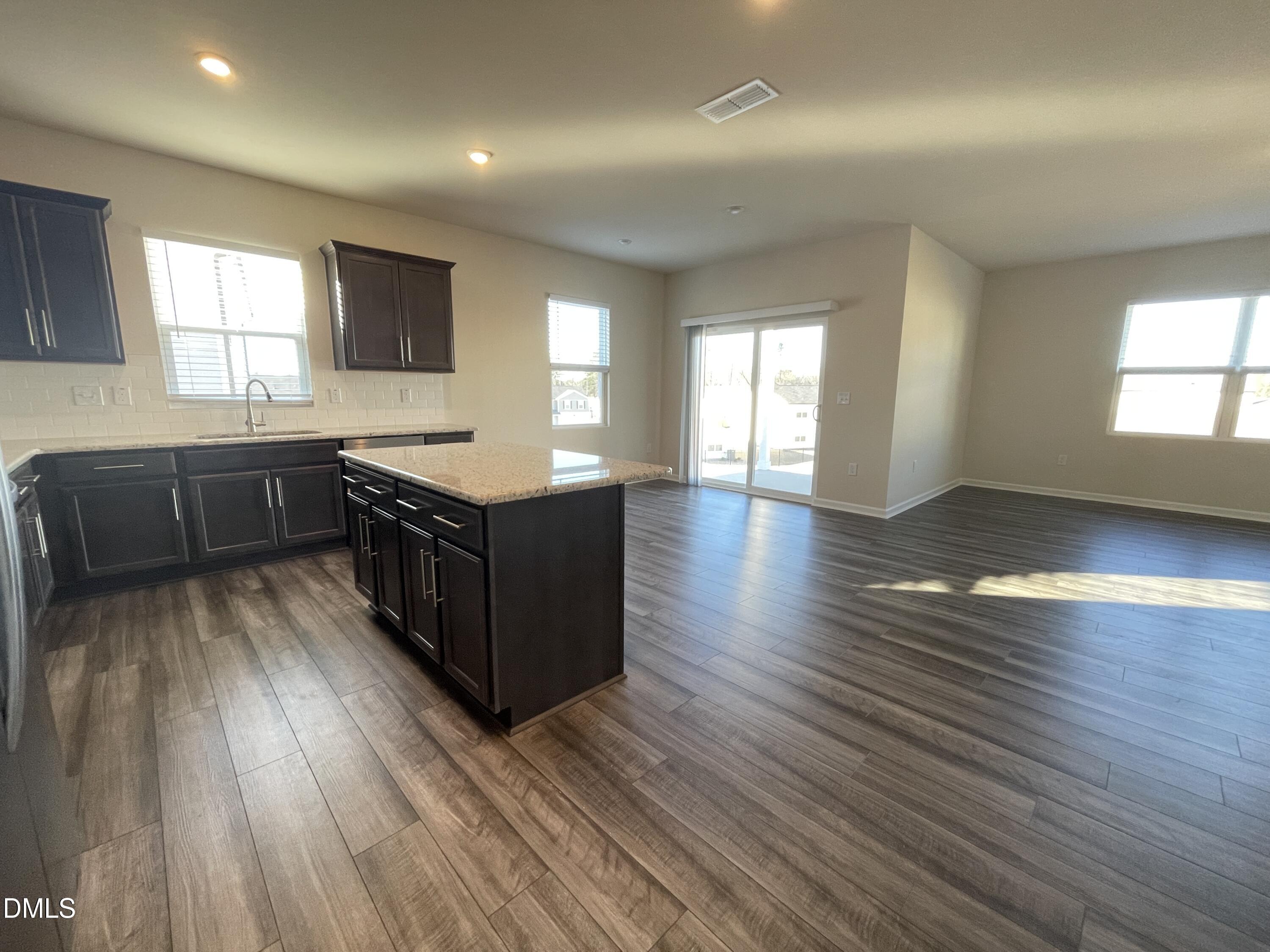3521 New Town Road Raleigh, NC 27604 - Photo 7 of 29 a kitchen with stainless steel appliances granite countertop a stove and a wooden floors