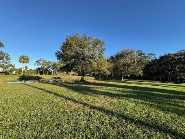 2150-2140 C Road Loxahatchee Groves, FL 33470 - Photo 11 of 14 a view of a swimming pool with an outdoor space and seating area