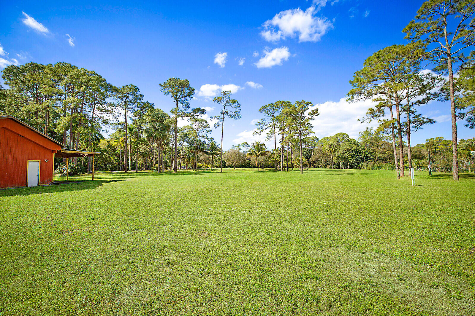 2150-2140 C Road Loxahatchee Groves, FL 33470 - Photo 13 of 14 a view of a building with a big yard