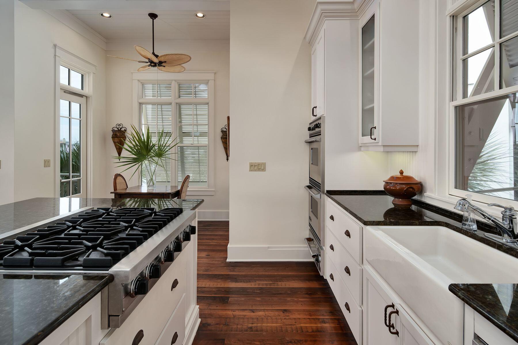 244 West Bermuda Drive Santa Rosa Beach, FL 32459 - Photo 12 of 66 a kitchen with stainless steel appliances a sink stove and cabinets