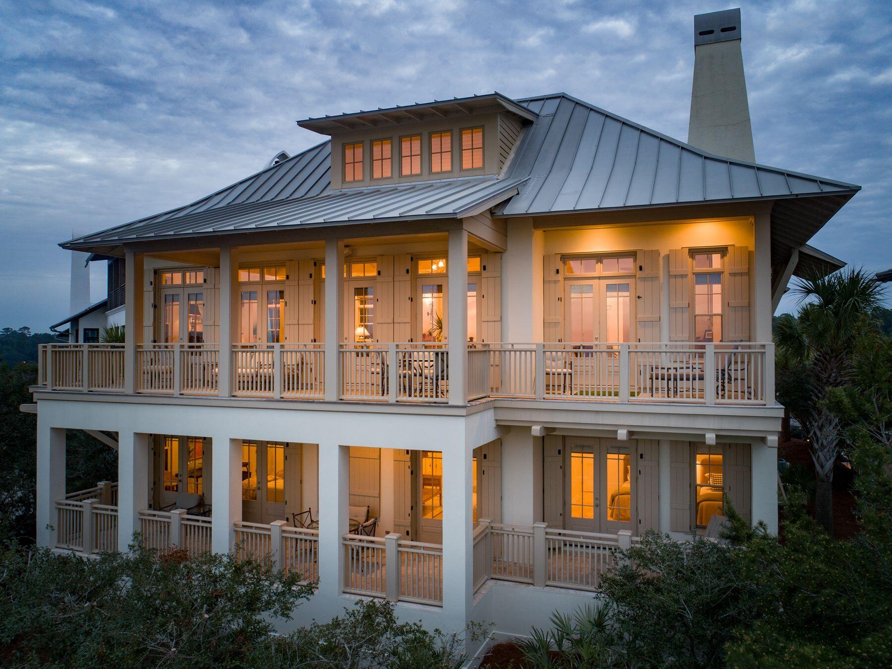 244 West Bermuda Drive Santa Rosa Beach, FL 32459 - Photo 2 of 66 a front view of a house with a glass windows and a table
