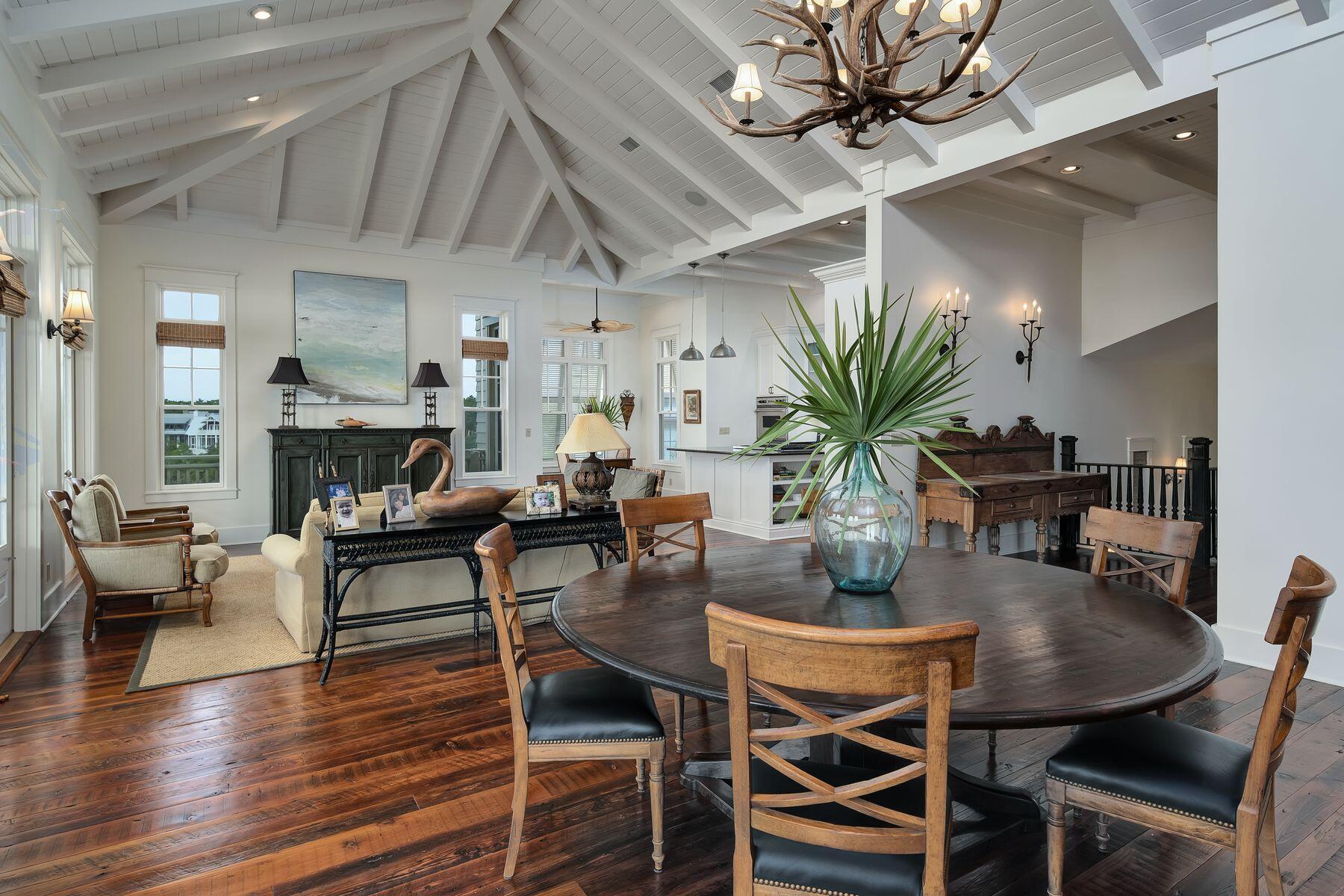 244 West Bermuda Drive Santa Rosa Beach, FL 32459 - Photo 27 of 66 a dining room with furniture potted plants and wooden floor
