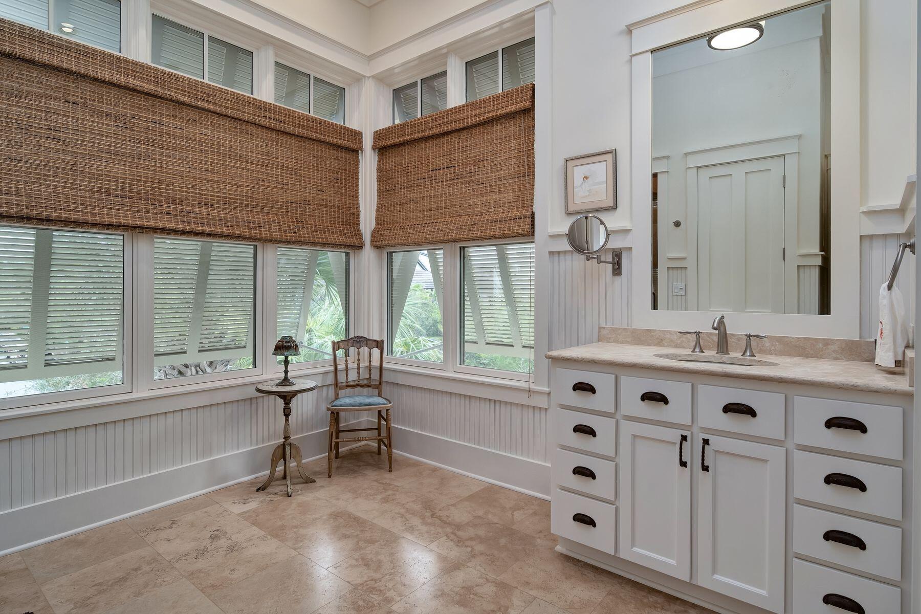 244 West Bermuda Drive Santa Rosa Beach, FL 32459 - Photo 30 of 66 a spacious bathroom with a double vanity sink a mirror and a bathtub