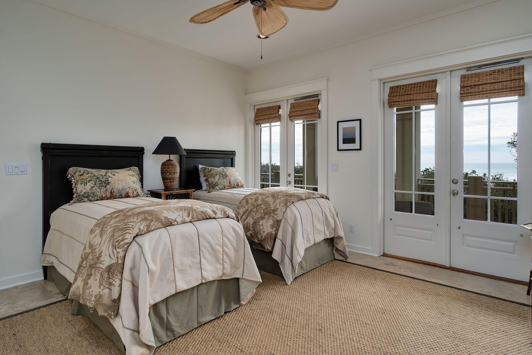 244 West Bermuda Drive Santa Rosa Beach, FL 32459 - Photo 38 of 66 a bedroom with a bed and glass door