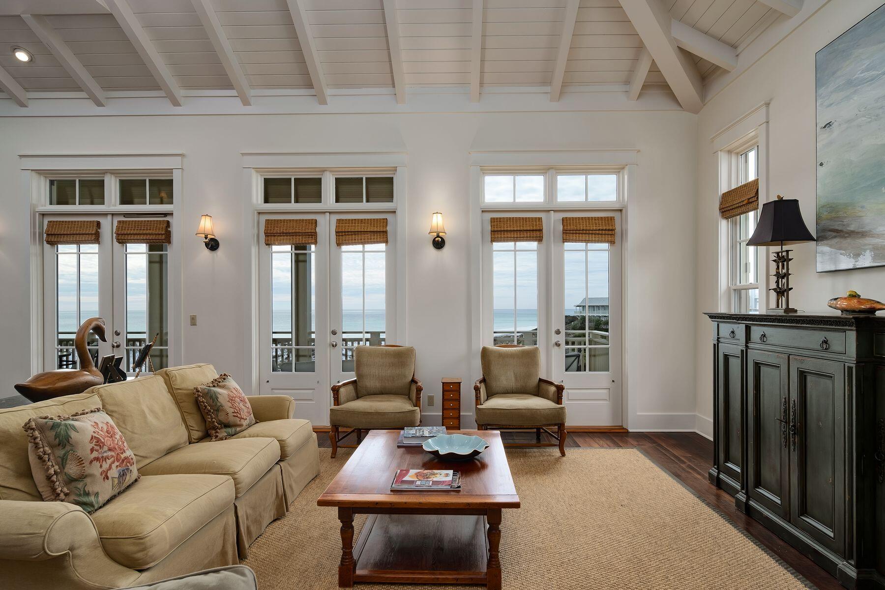 244 West Bermuda Drive Santa Rosa Beach, FL 32459 - Photo 8 of 66 a living room with furniture a fireplace and large windows