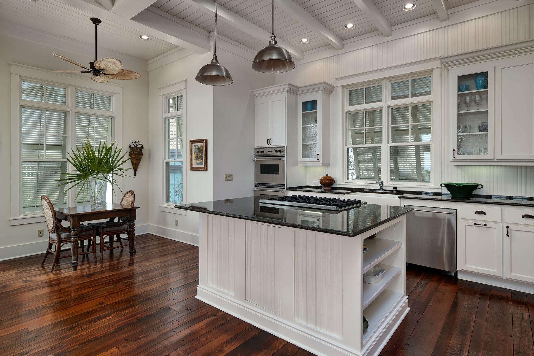 244 West Bermuda Drive Santa Rosa Beach, FL 32459 - Photo 10 of 66 a kitchen with stainless steel appliances granite countertop a stove and a wooden floors