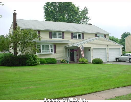26 Cross Hill Road Wethersfield, CT 06109 - Photo 1 of 1 a front view of a house with a garden