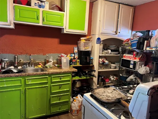 a kitchen with a sink and a stove next to a window
