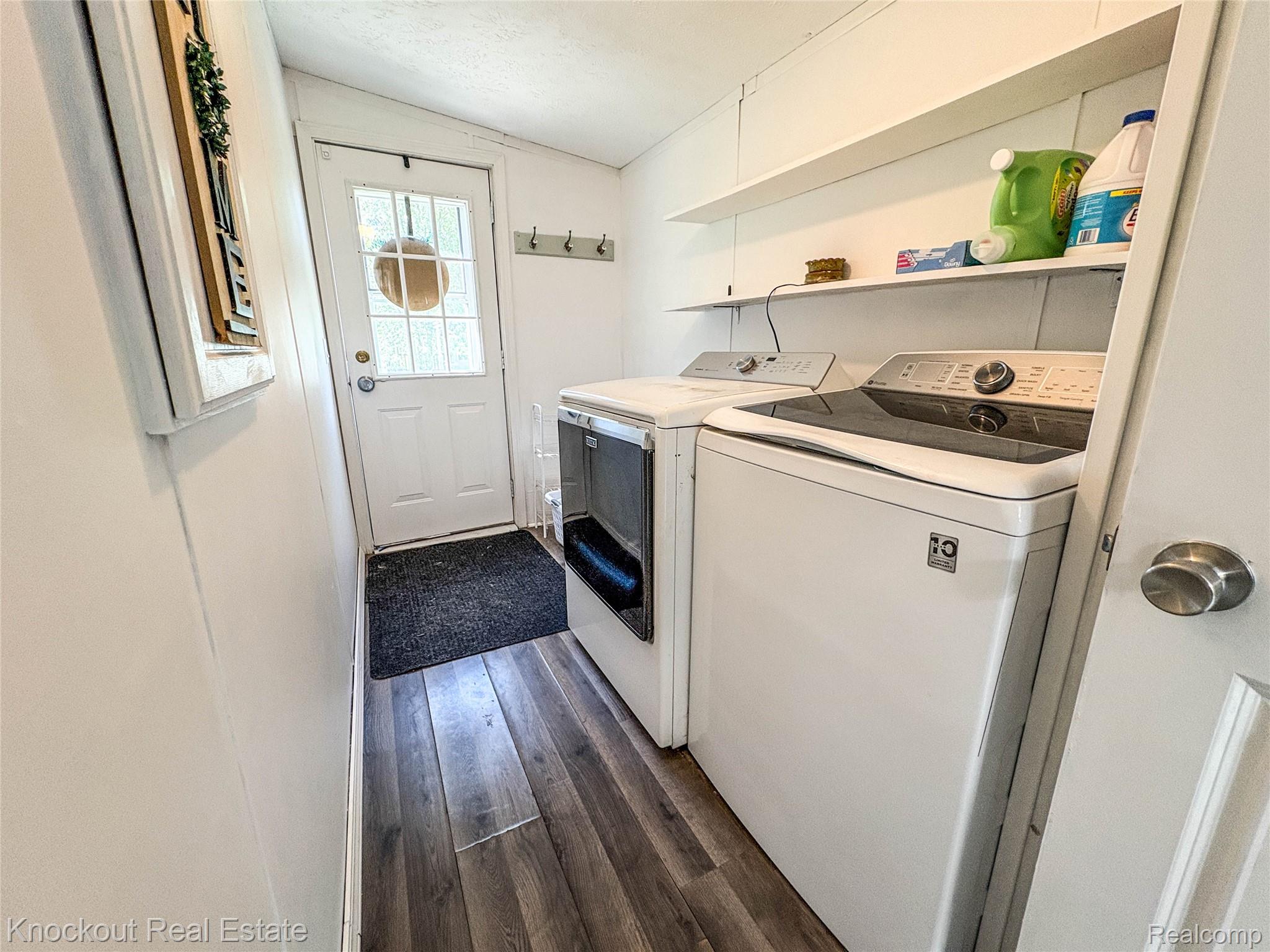 7760 Bell Road Birch Run, MI 48415 - Photo 51 of 68 Dedicated laundry area featuring wood-finish flooring, white paneled walls, and built-in shelving