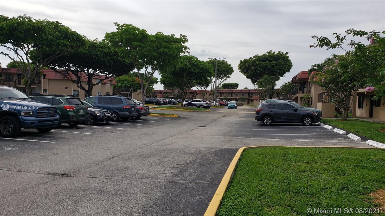 14857 Southwest 104th Street, Unit 9205 Miami, FL 33196 - Photo 11 of 11 a view of a street with cars parked