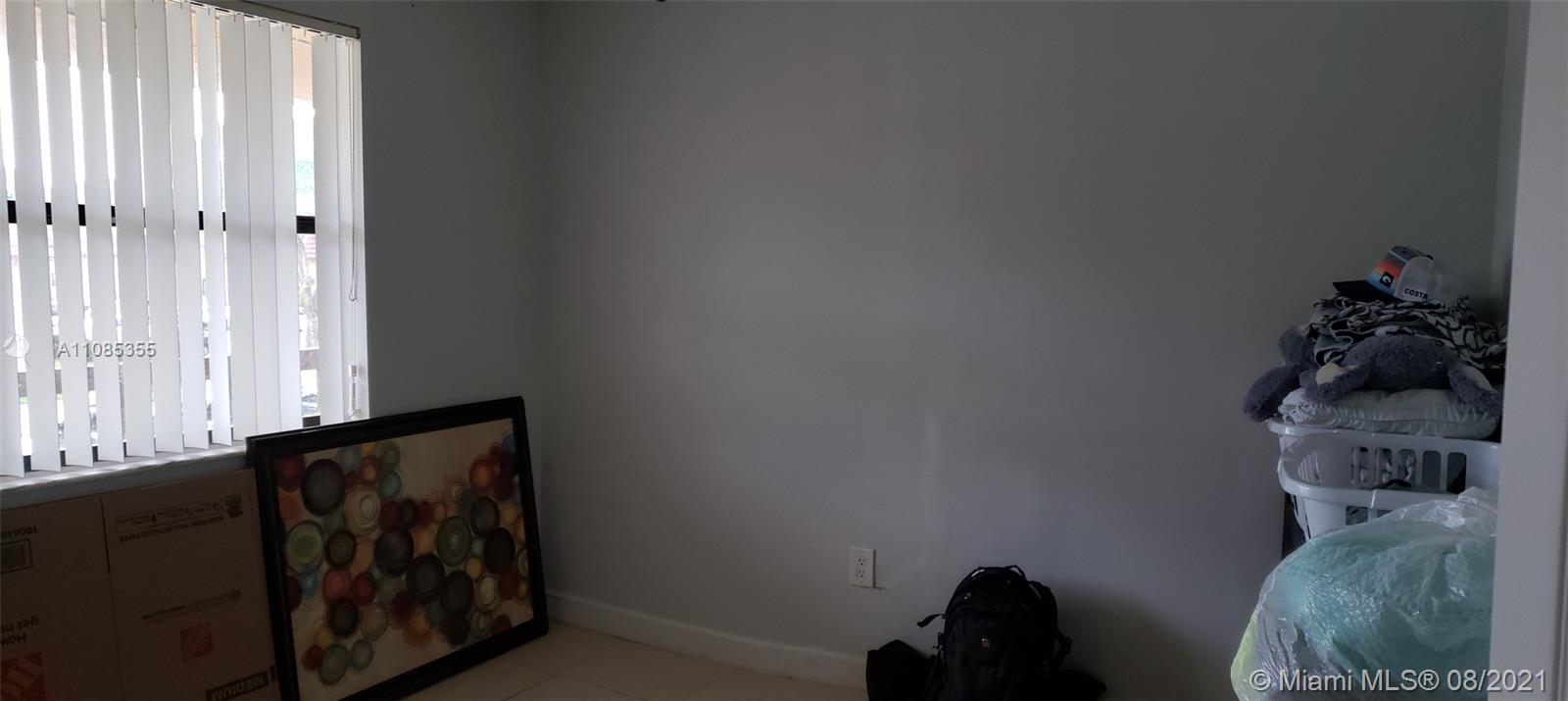 14857 Southwest 104th Street, Unit 9205 Miami, FL 33196 - Photo 9 of 11 a room with a lamp and a window