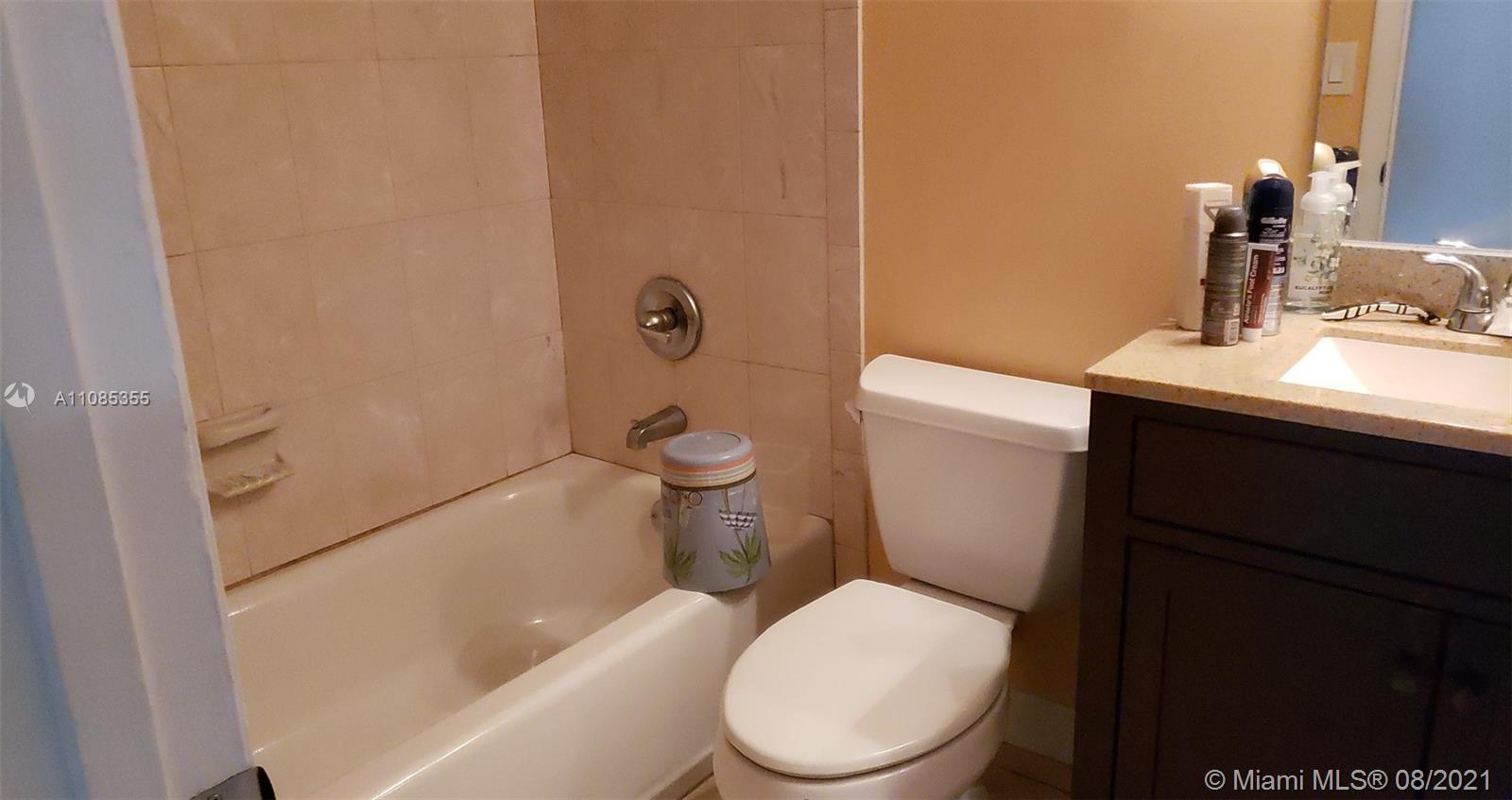 14857 Southwest 104th Street, Unit 9205 Miami, FL 33196 - Photo 10 of 11 a white toilet sitting next to a bathroom sink