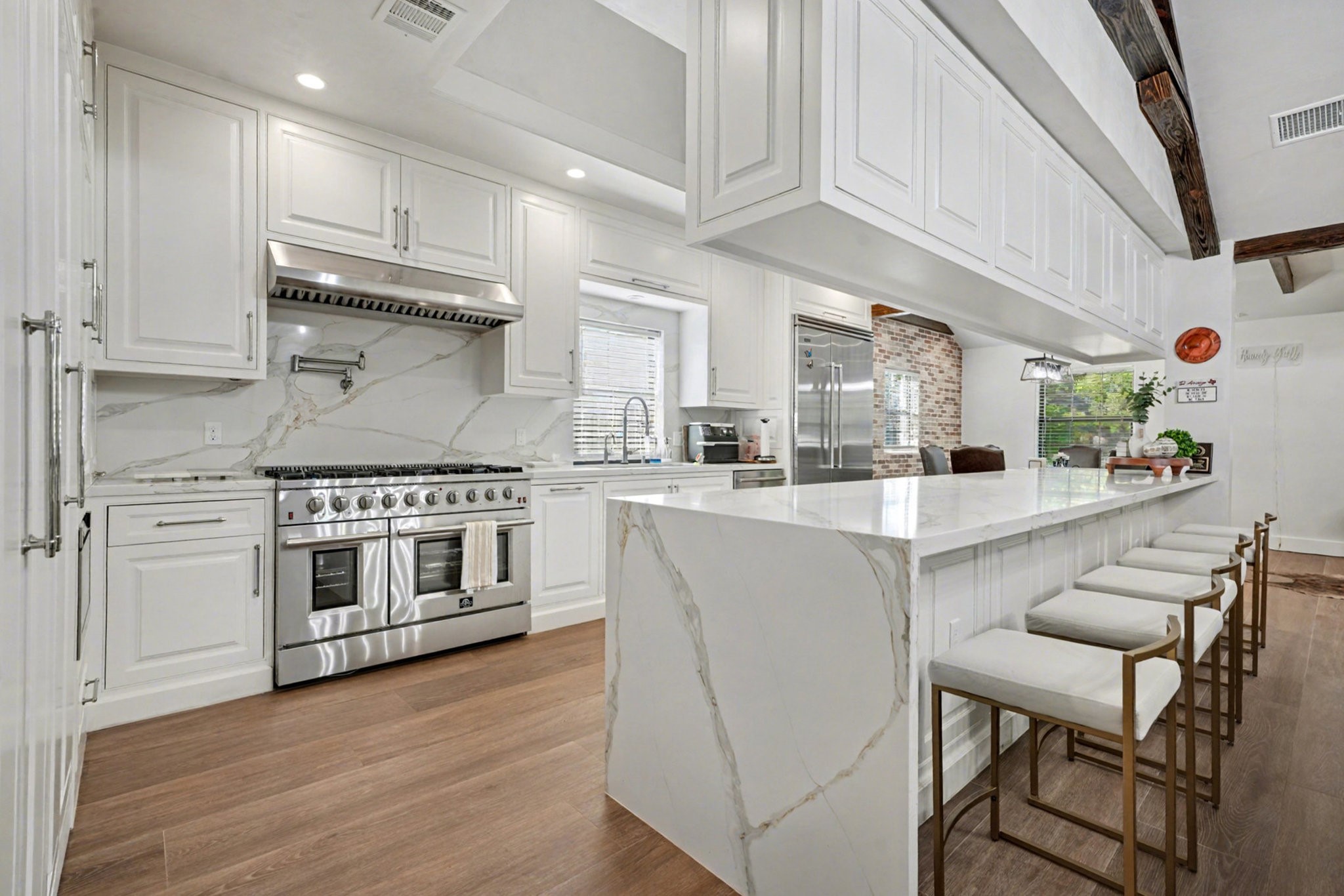 8515 Edgemoor Drive Houston, TX 77036 - Photo 14 of 33 a kitchen with stainless steel appliances white cabinets and wooden floor